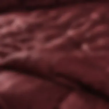 Close-up of the rich fabric texture of a burgundy comforter