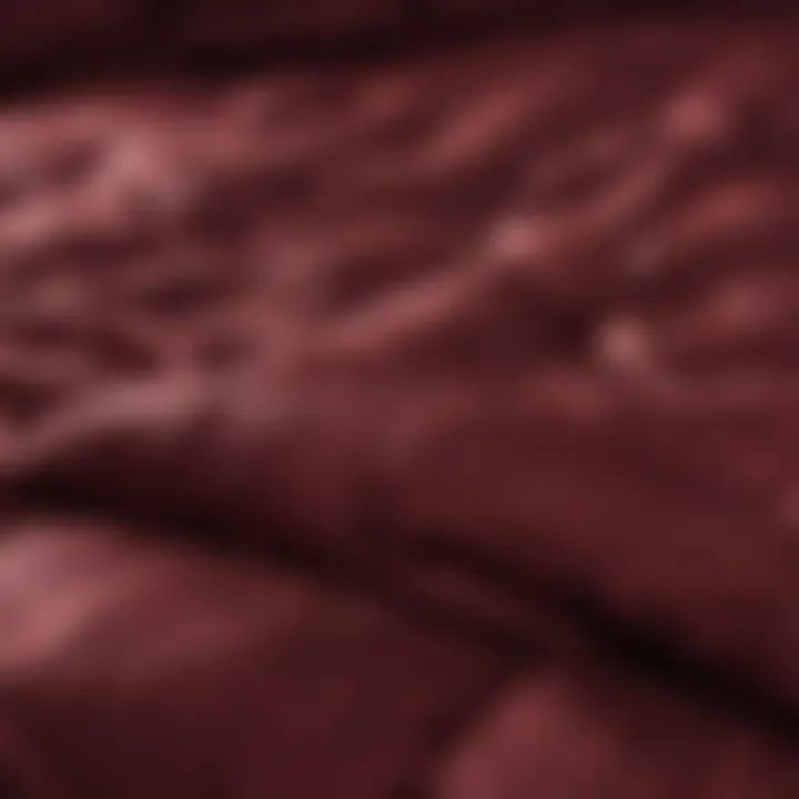 Close-up of the rich fabric texture of a burgundy comforter