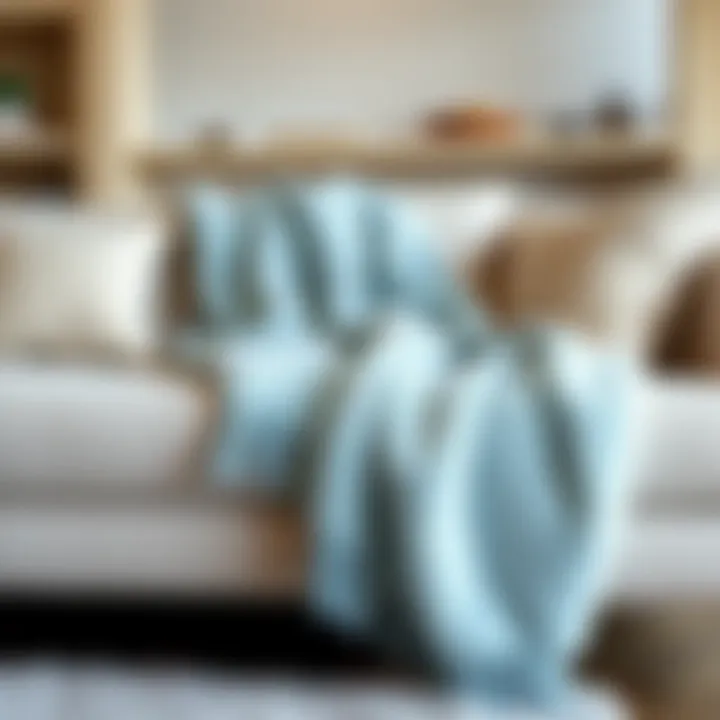 Light blue UGG blanket draped elegantly on a sofa