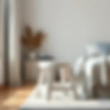 Small white wooden stool used as a decorative element in a minimalist bedroom